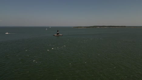 An-aerial-view-the-Orient-Point-lighthouse-off-the-east-end-of-Orient-Point,-NY-on-a-sunny-day