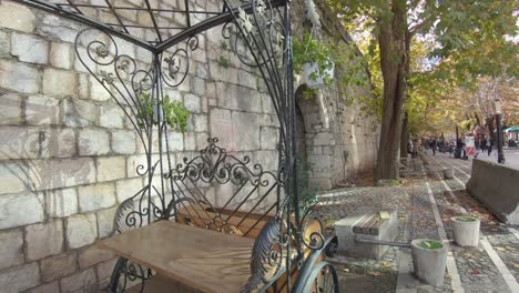 Leisure-walkway-next-to-Walls-of-the-Fort-of-Justinian-in-Tirana,-Albania---Wide-push-in-gimbal-shot