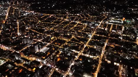 cinematic nighttime drone footage of batumi skyline and illuminated skyscrapers.