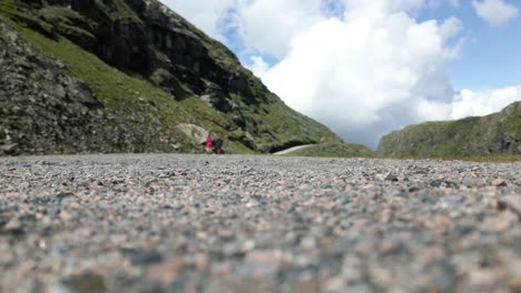 Two-Females-Walking-on-a-Stone-Trail-along-the-Side-of-a-Mountain