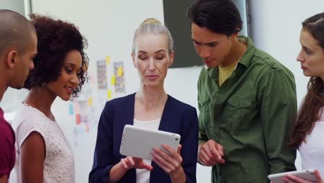 colleagues discussing over digital tablet 4k