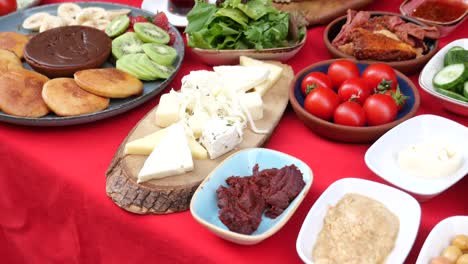 traditional turkish breakfast with cheese, tomatoes, olives, bread, and fruit