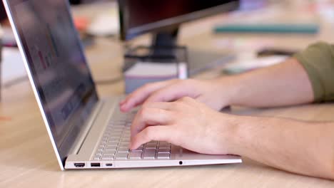 Hands-of-asian-female-creative-working-at-laptop-computer-in-casual-office,-slow-motion