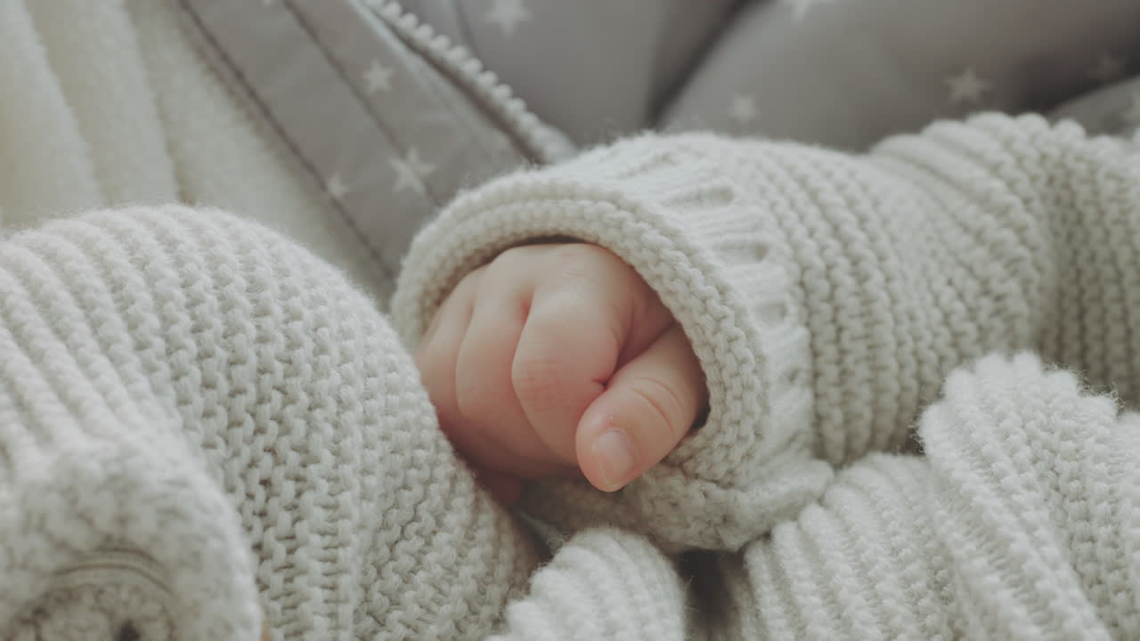 Baby's Hands in Knitted Sweater