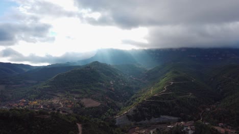 Majestic-view-of-Montserrat-and-Marganell-Mountains-with-sun-rays-breaking-through-clouds