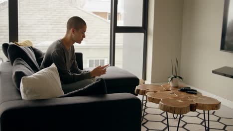 young man using mobile at home 4k