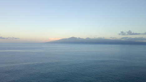 vast pacific ocean ripple wave and silhouette of tropical island