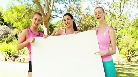 Group-of-volunteers-holding-a-blank-sheet