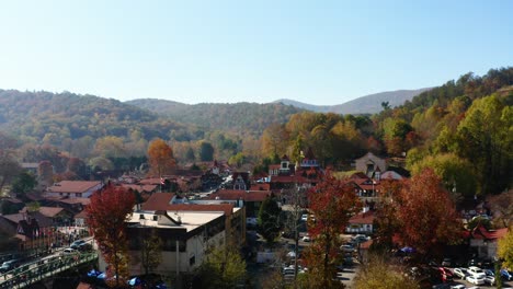 slowly rising above the fall colors in alpine village of helen georgia