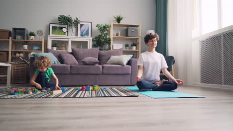 mother meditating while child plays