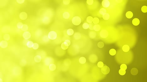 partículas de oro suaves en movimiento sobre un fondo amarillo verdoso- vídeo sin costuras de 4k
