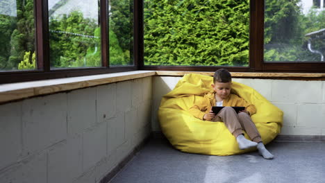 kid sitting on hassock