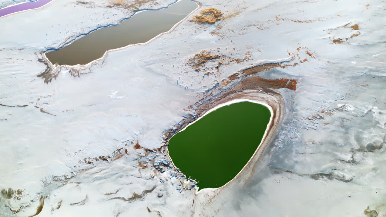 Aerial drone view of colorful salt ponds and mineral pools in a dry desert landscape in Utah, United States