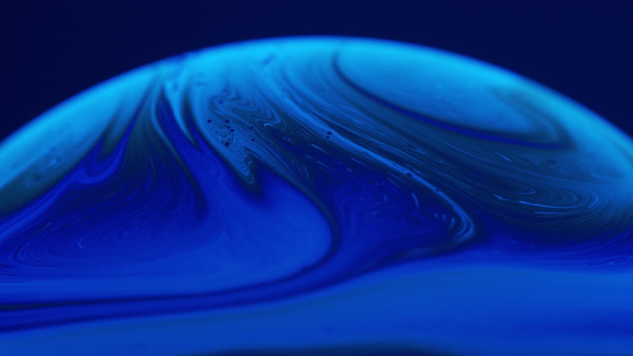 Primo piano macro di soluzione liquida che crea bellissimi vortici blu intenso.