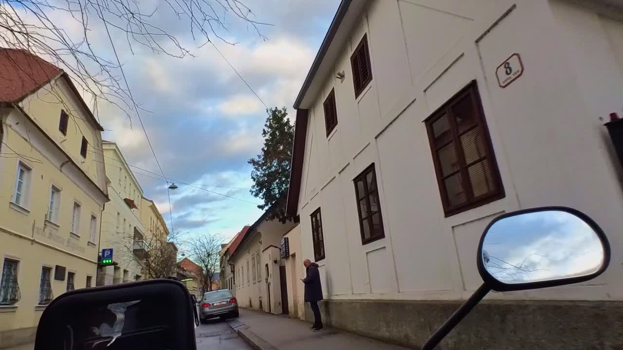 A POV shot of the handlebar of a small motorcycle with the smartphone mounted on it.