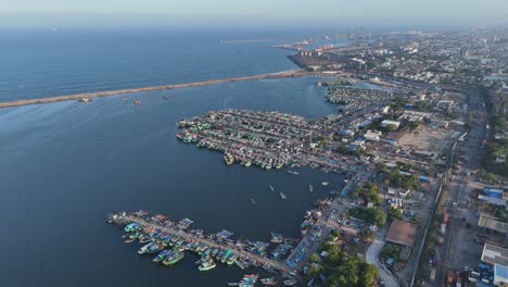 drone shot showing group of boats with monsoon clouds over the north chennai skyline