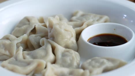 plate of dumplings with soy sauce