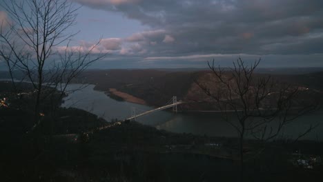 bridge crossing from top of mountain over hudson river at night in upstate new york