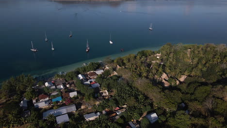 idyllic view of sailboats at the coastal town in the tropical island of sumba, indonesia