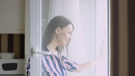 woman looking out window in kitchen