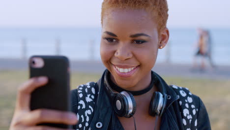 Selfie,-beach-and-black-woman-with-headphones