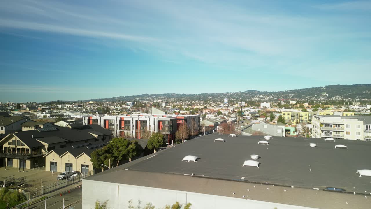 The aerial perspective reveals the blend of historic architecture and modern development across Jingletown and Fruitvale districts.