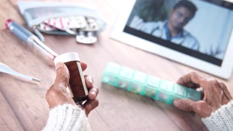 elderly person taking medicine consultation with doctor via video call