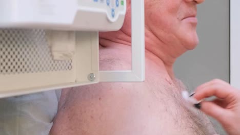 a cardiologist makes cardiogram to patient. female hands of professional doctor hold cardiogram for further examination of sick man in modern clinic. latest technologies in medicine.