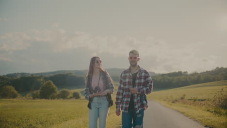 friends talking and walking near meadow