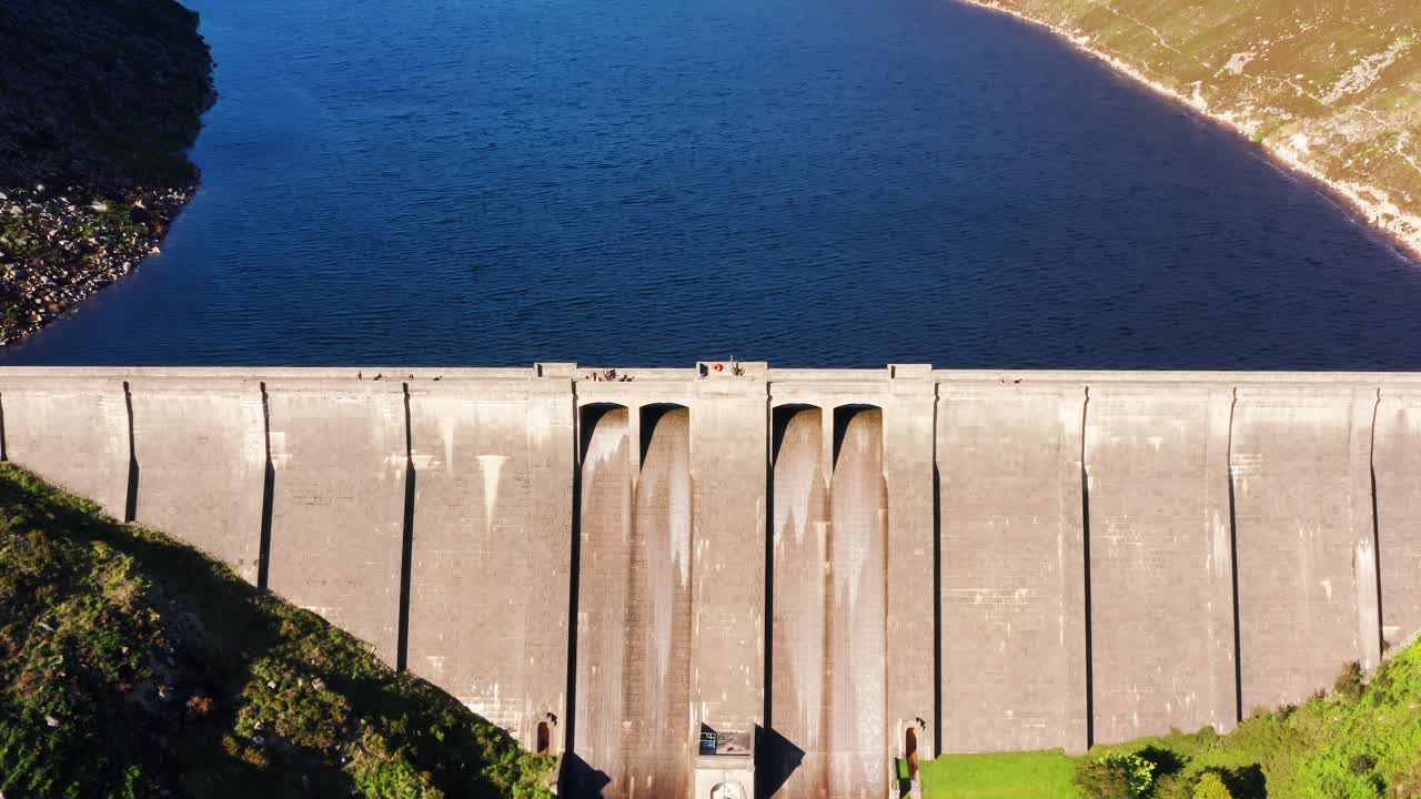 Aerial View of Visitors Walking Along the Ben Crom Reservoir Surrounded by Mourne Mountains