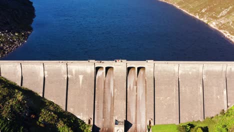 aerial view of visitors walking along the ben crom reservoir surrounded by mourne mountains