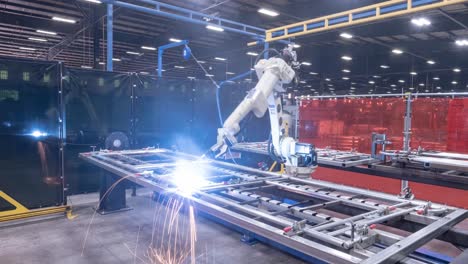 timelapse of a robotic welder moving around a steel frame and putting in welds with fire and sparks