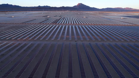 solar power plant, aerial view of massive array of solar panels in desert landscape, drone shot