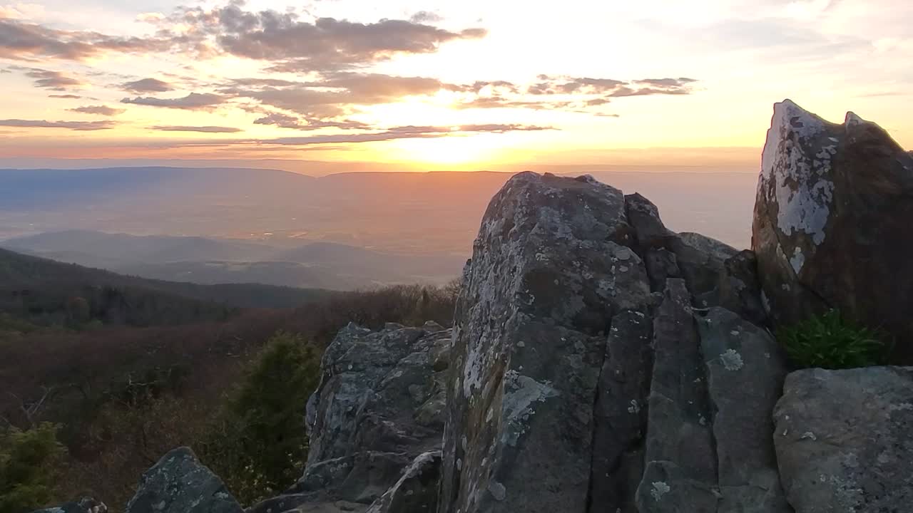 Sun setting over mountains stock
