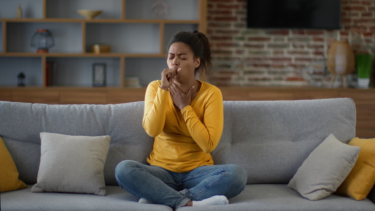 Woman Coughing on a Couch