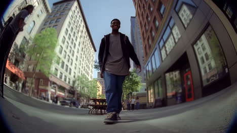 young man walking on city street with wide-angle view