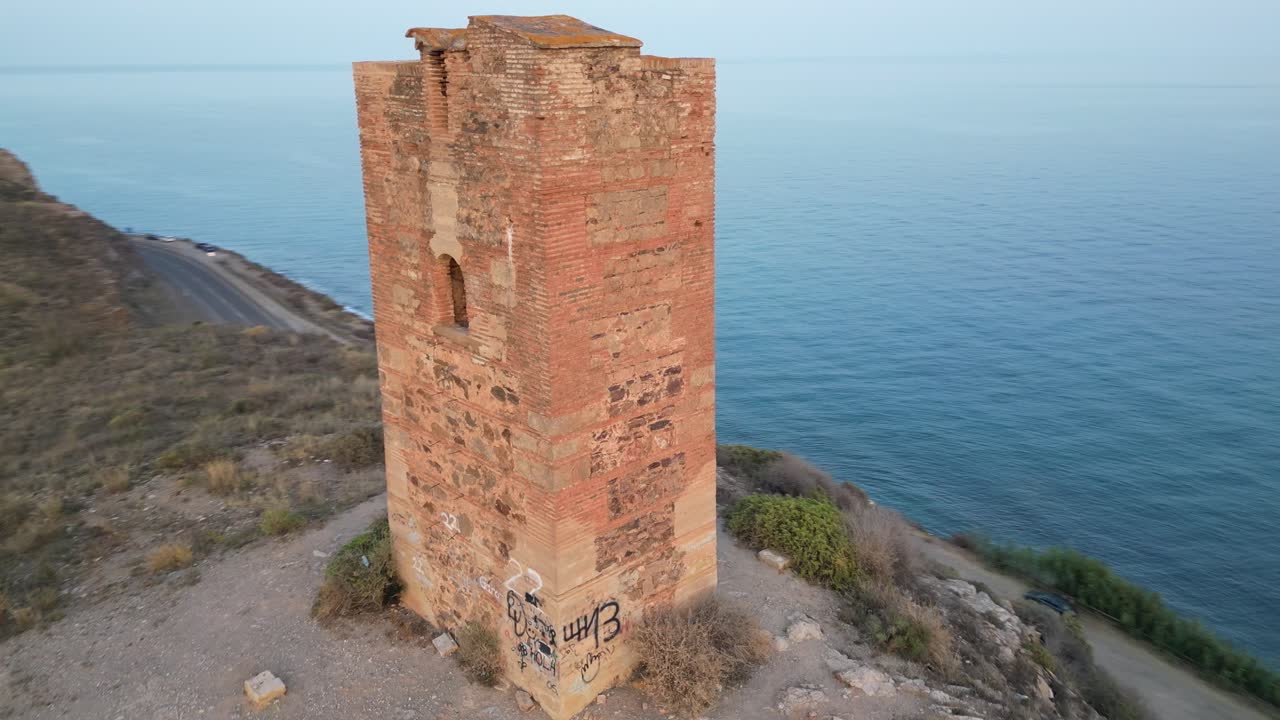 Experience the historic Tower of Jaral in Almayate Bajo from a mesmerizing drone's-eye view