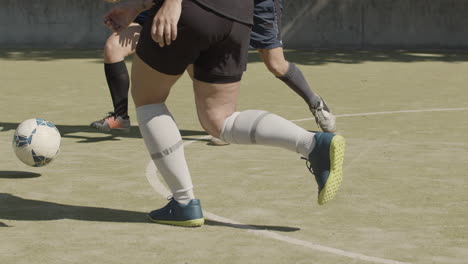 tiro de seguimiento de deportistas irreconocibles jugando al fútbol en el campo