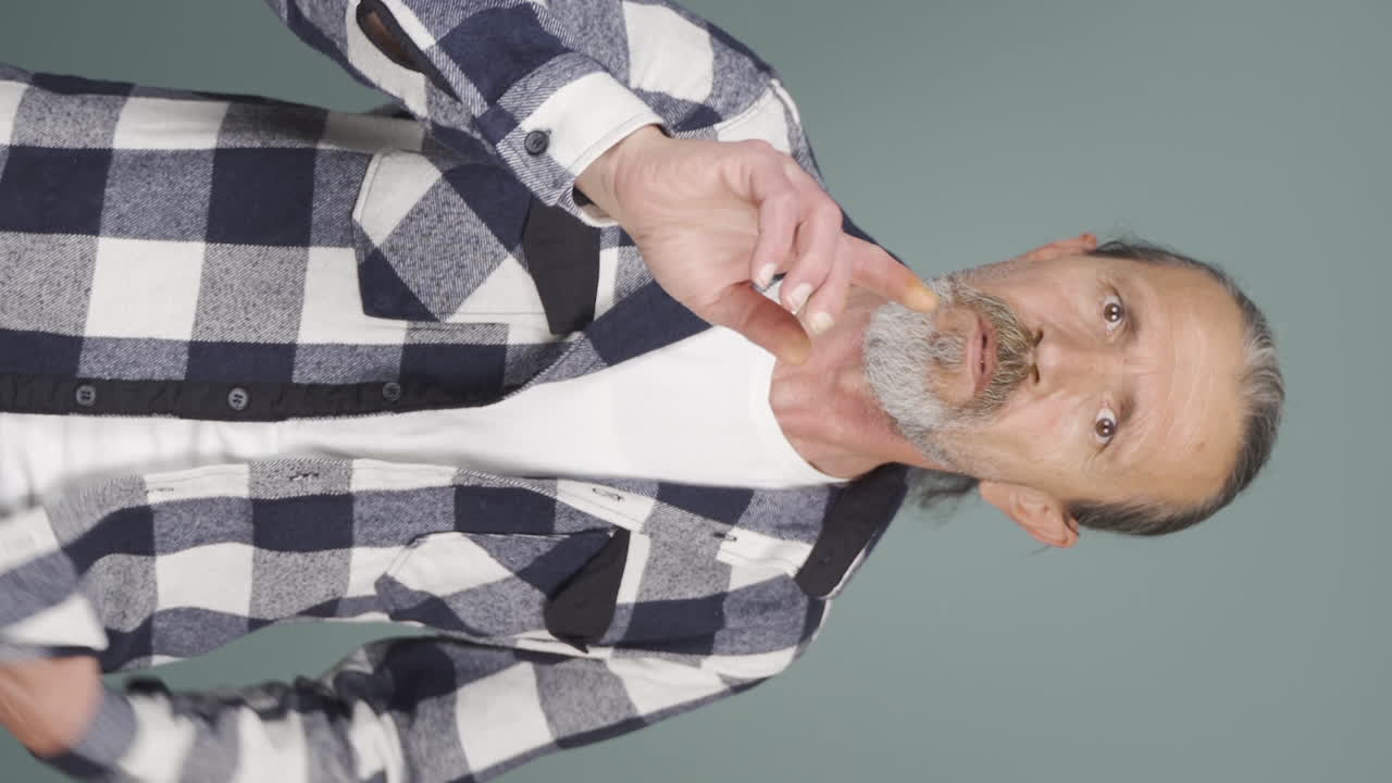 Vertical video of Old man giving motivational speech to camera.