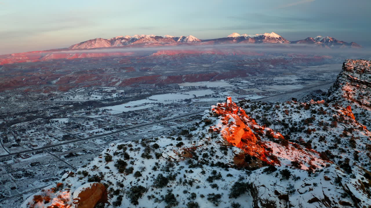 Panoramic Winter Landscape of a Valley with Snow-Capped Mountains and Red Rocks at Sunrise