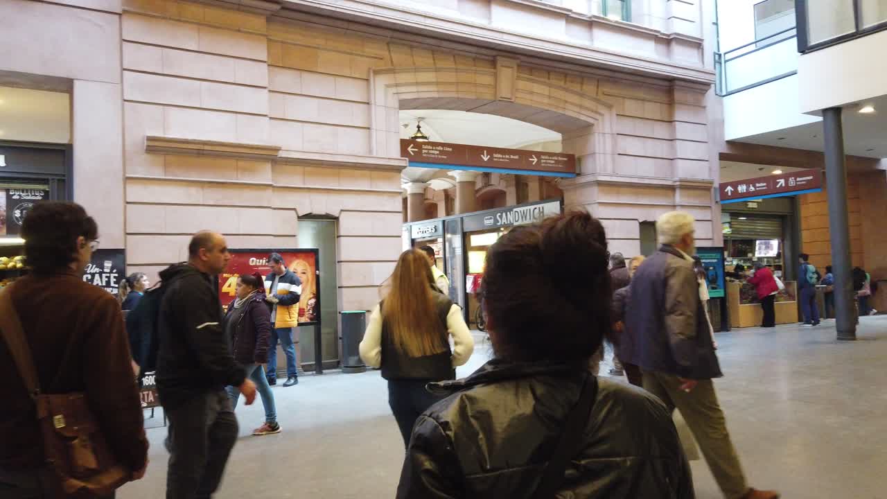 POV Walking inside Constitución railway station of Buenos Aires city people and stores, famous transportation Argentine landmark