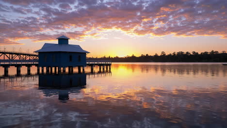 stilt house on water at sunset