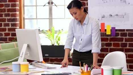 Pretty-designer-working-at-her-desk-on-computer