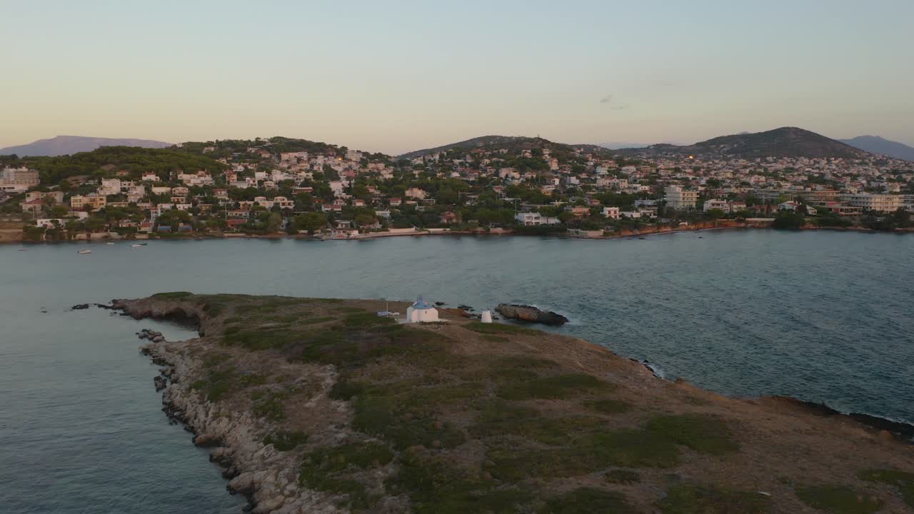 vista aérea de drones de una iglesia blanca durante el amanecer en grecia
