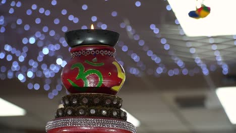 turning hindu lamp with om and swastika symbols during havan ceremony 1