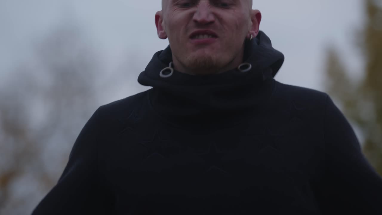 joven saltando la cuerda al aire libre con una capucha negra