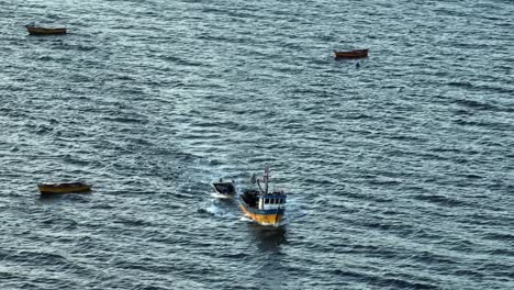 aerial view of motorised fishing boat sailing across waters off chile