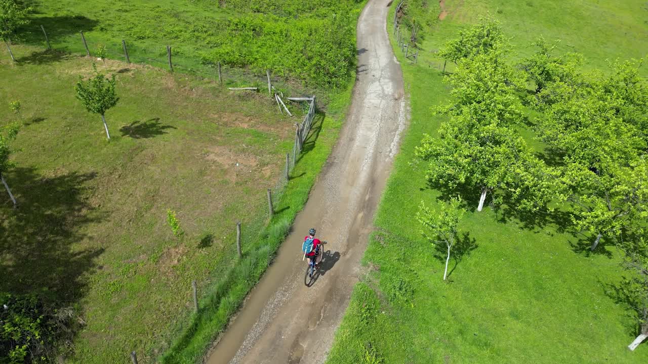 Drone shot of mountain bike rider, slow motion.