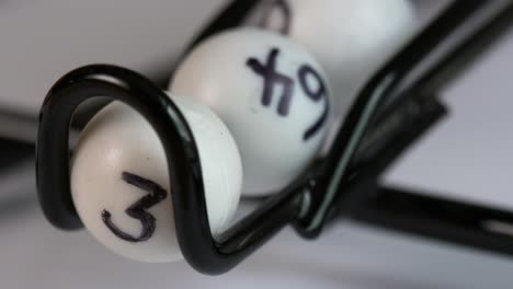 close-up of a lottery or bingo ball catcher as the winning numbers roll out