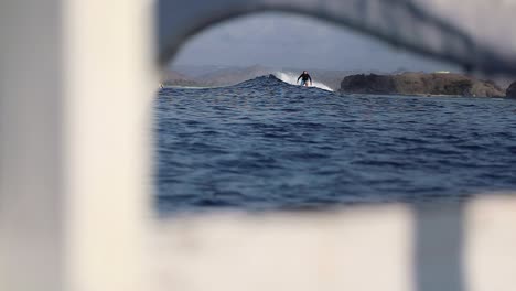 beginner surfers ride the wave smoothly on a gloomy day - slow motion shot